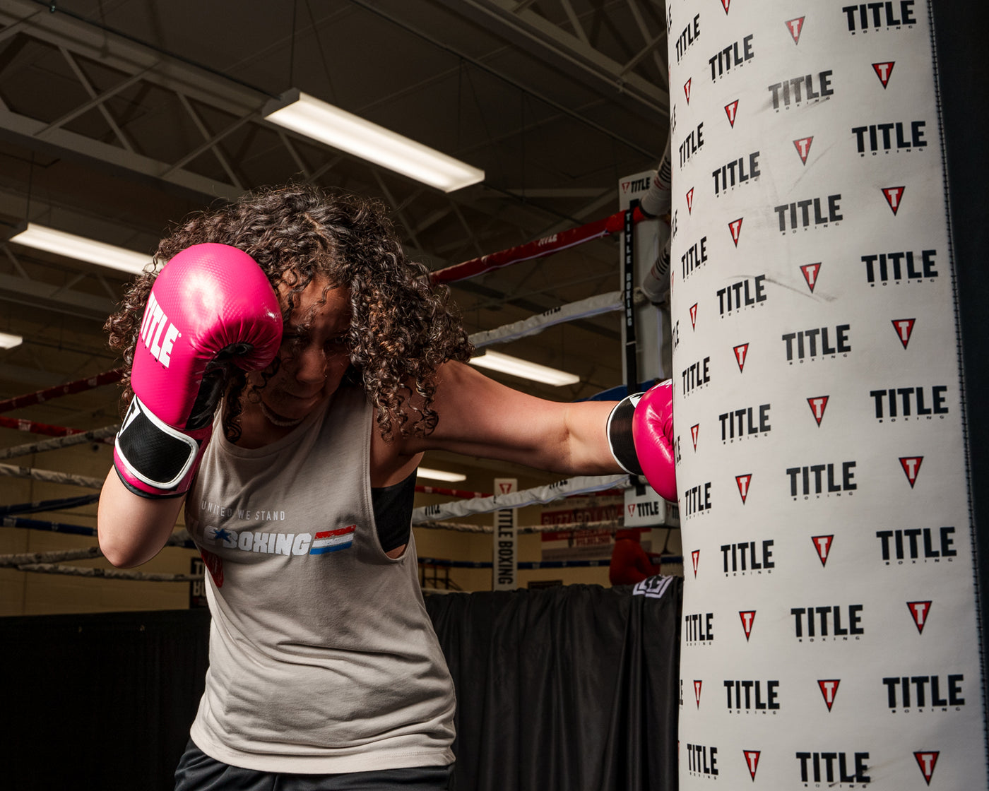 variant:pink/black::TITLE Boxing Instinct Fitness Bag Gloves girl wearing boxing gloves punching heavy bag