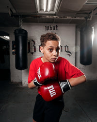 variant:red/black::TITLE Boxing Instinct Fitness Bag Gloves kid posing with boxing gloves
