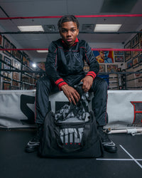 variant:black::TITLE Boxing Individual Sport Bag kid pulling out wraps out of bag