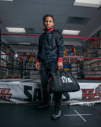variant:black::TITLE Boxing Individual Sport Bag kid holding bag