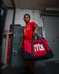 variant:red::TITLE Boxing Individual Sport Bag guy holding out bag