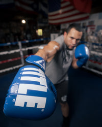 variant:Blue/White::TITLE Boxing Inferno Intensity Elastic Training Gloves man throwing punch