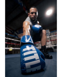variant:Blue/White::TITLE Boxing Inferno Intensity Elastic Training Gloves man posing in ring