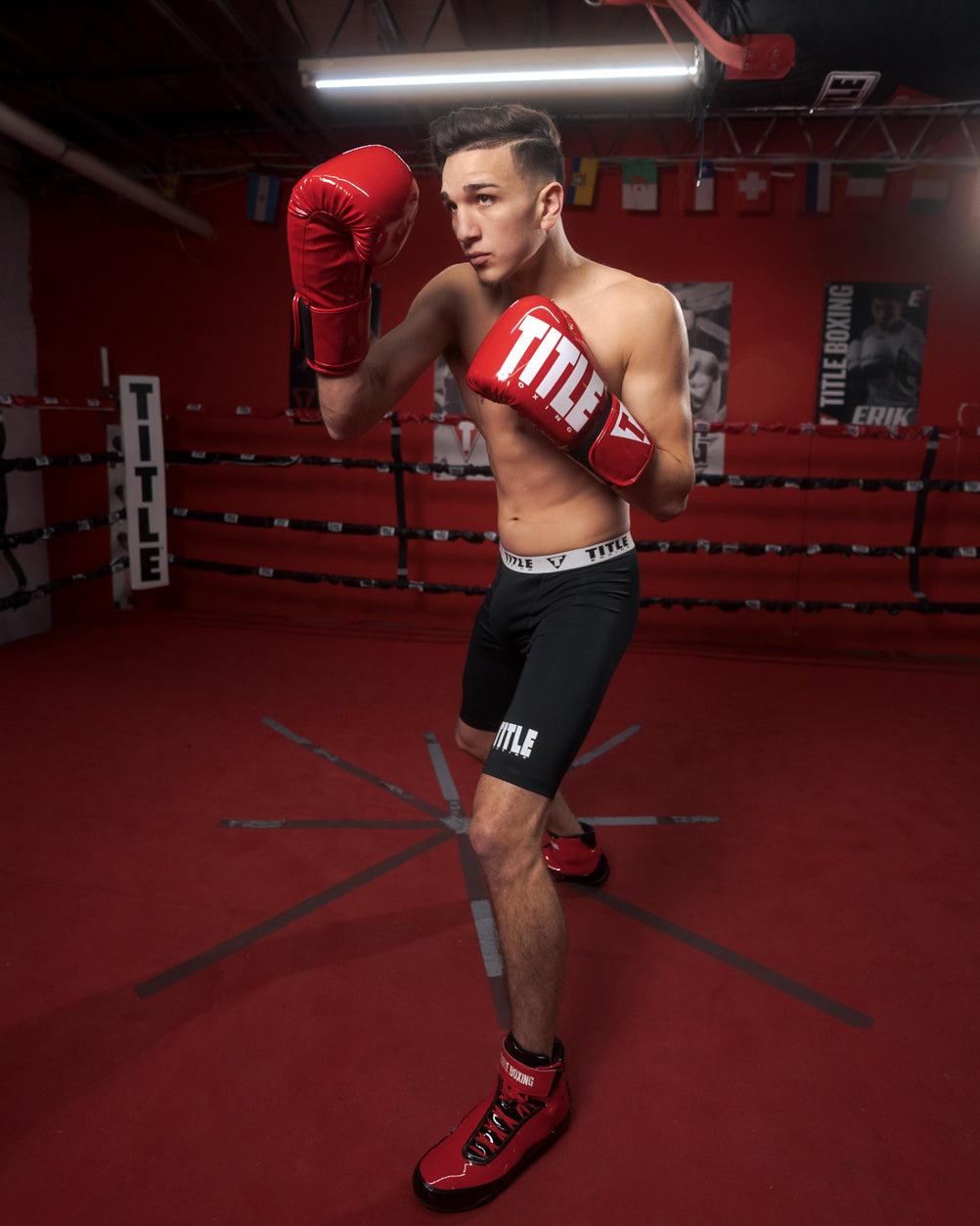 variant:Red/White::TITLE Boxing Inferno Intensity Elastic Training Gloves man posing in gloves