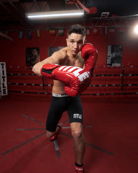 variant:Red/White::TITLE Boxing Inferno Intensity Elastic Training Gloves man wearing gloves posing