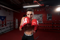 variant:Red/White::TITLE Boxing Inferno Intensity Elastic Training Gloves boy posing in ring