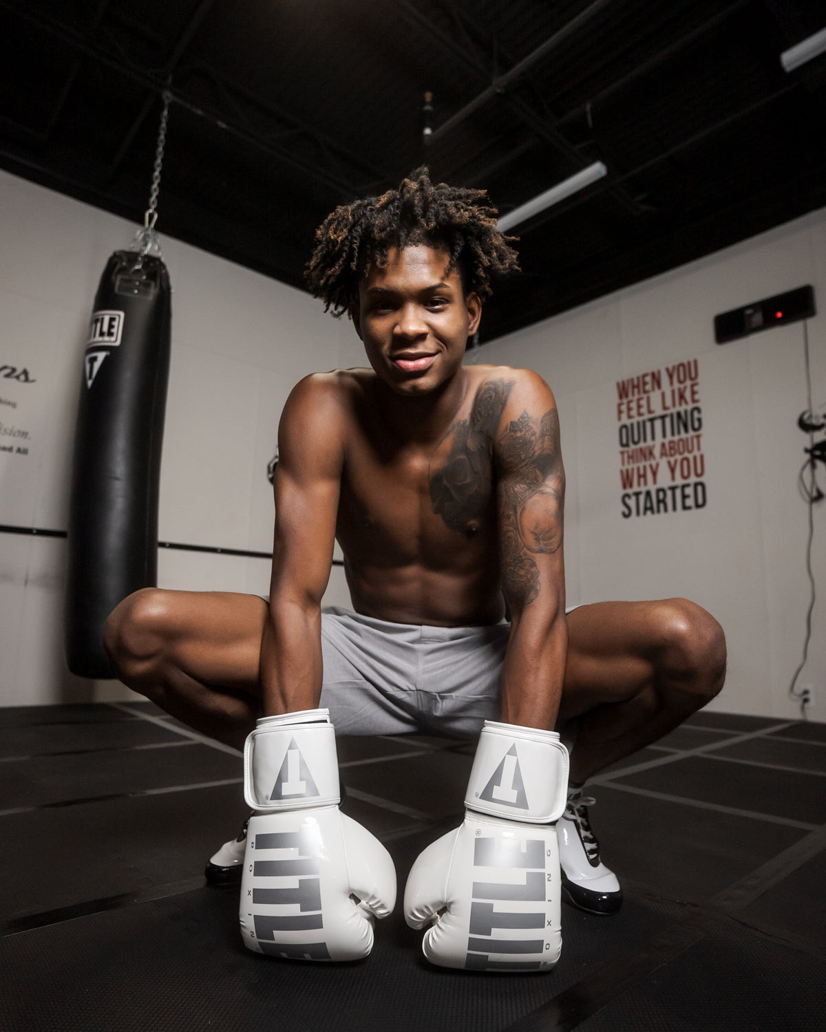 variant:White::TITLE Boxing Inferno Intensity Elastic Training Gloves man posing in gym wearing gloves