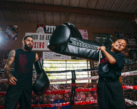 variant:black::TITLE Boxing Jumbo Boxing Gloves 2.0 guy and kid in boxing ring with jumbo boxing gloves