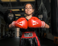 variant:red/black/white::TITLE Classic Kid & Youth Boxing Gloves 2.0 girl posing with boxing gloves