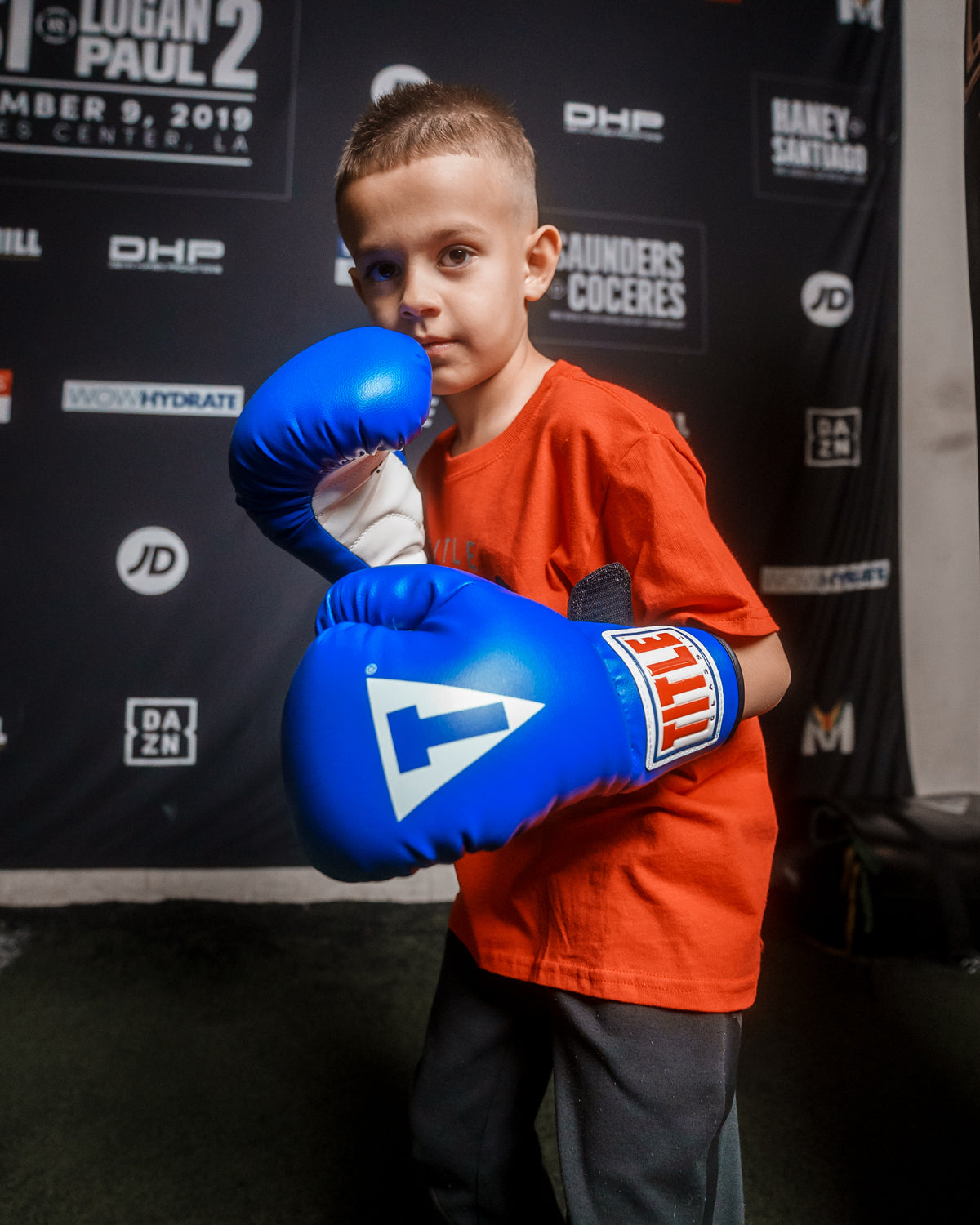 variant:blue/black/white::TITLE Classic Kid & Youth Boxing Gloves 2.0 kid posing with boxing gloves