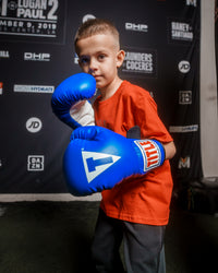 variant:blue/black/white::TITLE Classic Kid & Youth Boxing Gloves 2.0 kid posing with boxing gloves