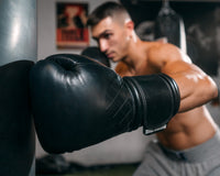 variant:black::TITLE Boxing Ko-Vert Bag Gloves guy wearing boxing gloves