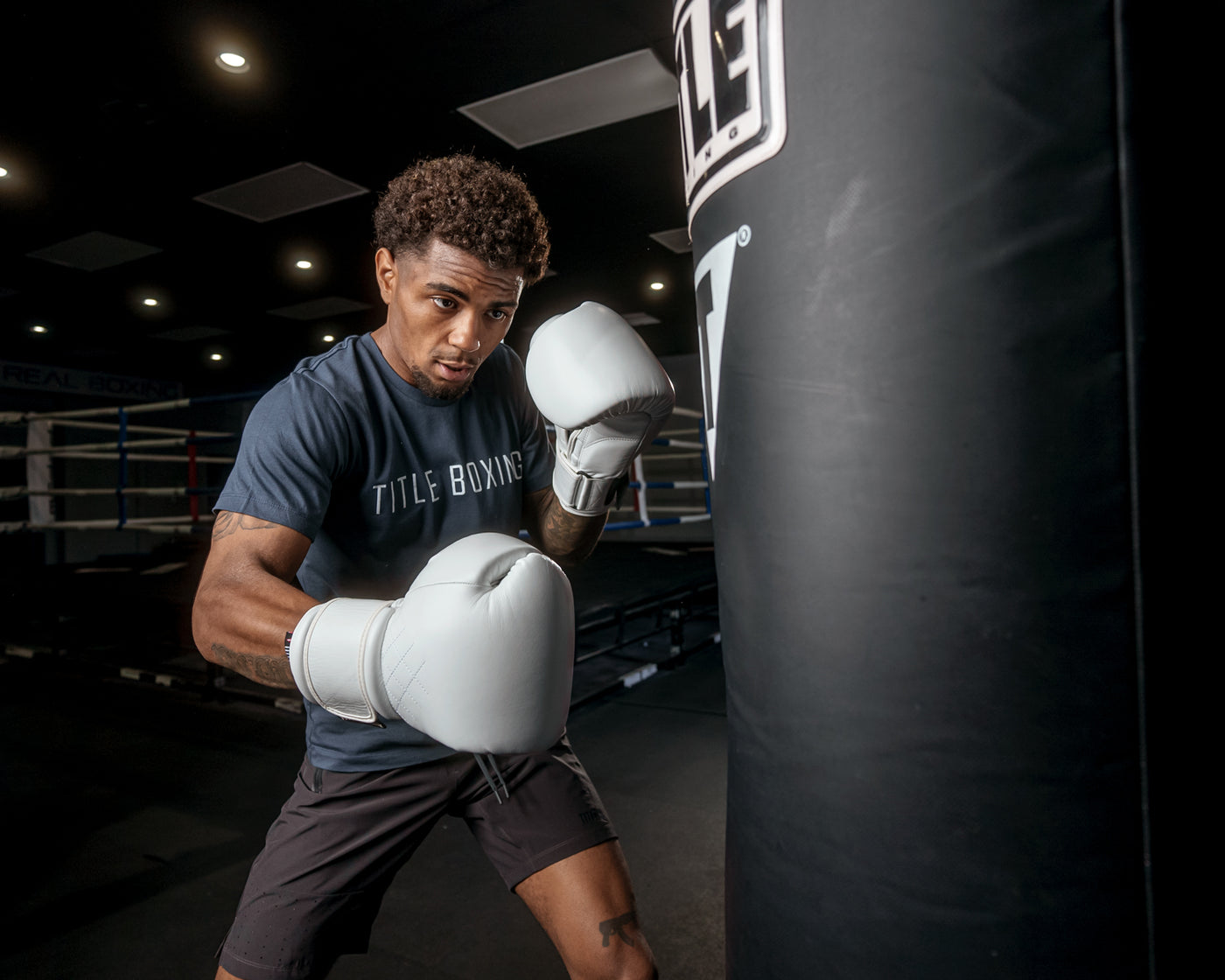 variant:white::TITLE Boxing Ko-Vert Bag Gloves guy wearing boxing gloves boxing with heavy bag