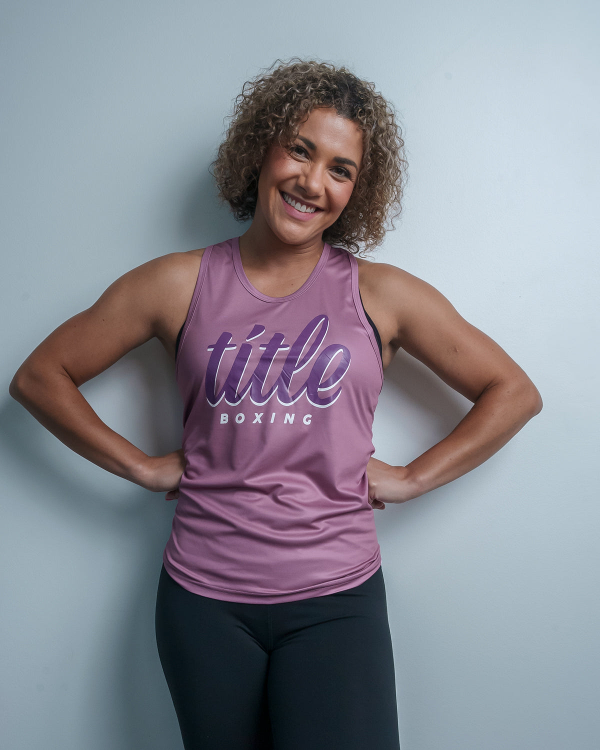 variant:purple::TITLE Boxing Script Racerback Women's Tank woman posing in tank top