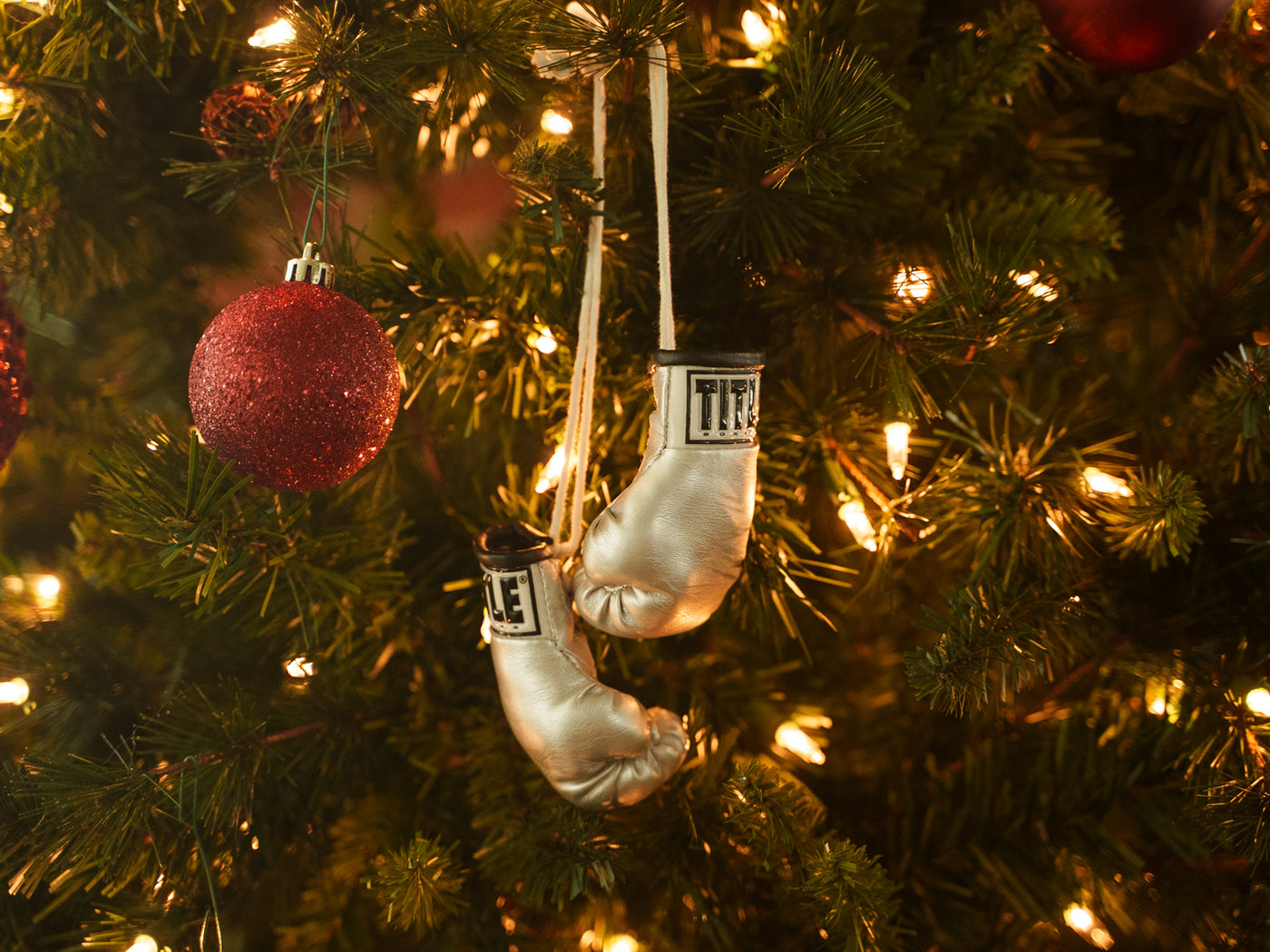 variant:shiny gold::TITLE Boxing 3.5” Mini Boxing Gloves hanging on Xmas tree