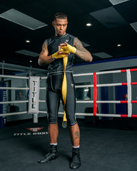 variant:Gold::TITLE Boxing Mexican Style 180" Hand Wraps guy wrapping hands with hand wraps