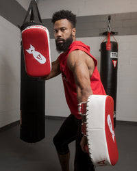 variant:red/white/black::TITLE MMA Air Raid Thai Pads (Pair) guy in standing pose