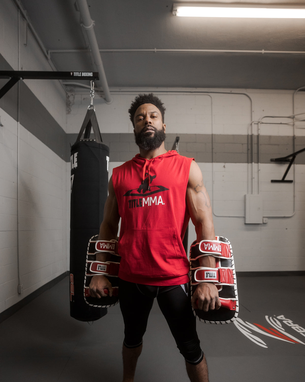 variant:red/white/black::TITLE MMA Air Raid Thai Pads (Pair) guy with hands down