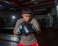 variant:black::Pro Mex Professional Training Gloves 3.0 kid swinging on bag