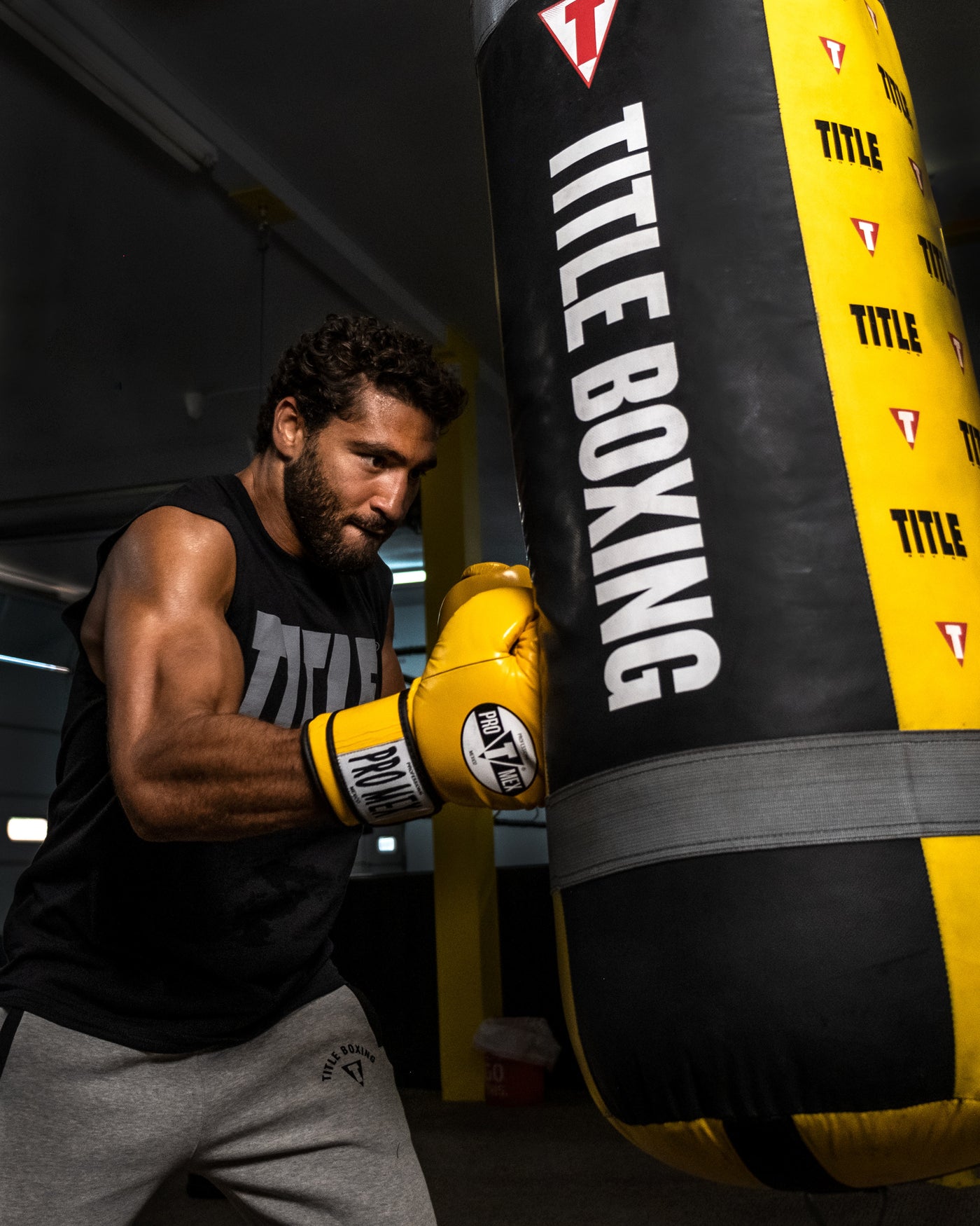 variant:yellow::Pro Mex Professional Training Gloves 3.0 guy hitting bag