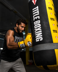variant:yellow::Pro Mex Professional Training Gloves 3.0 guy hitting bag