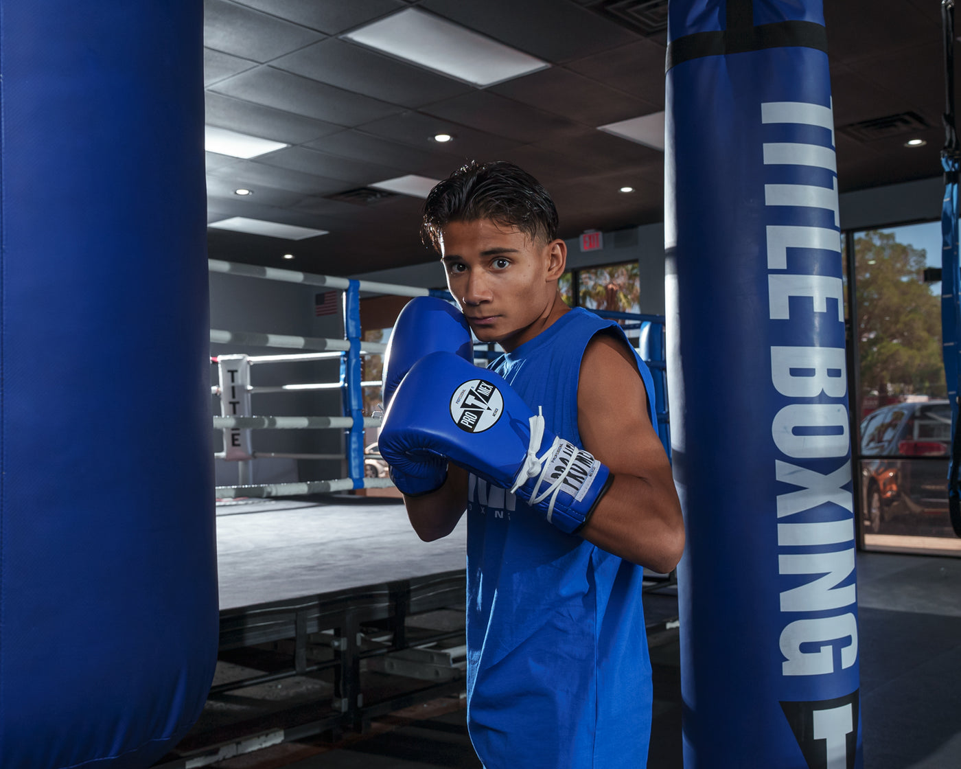 variant:Blue/White::Pro Mex Professional Lace Sparring Gloves V3.0 kid boxing pose