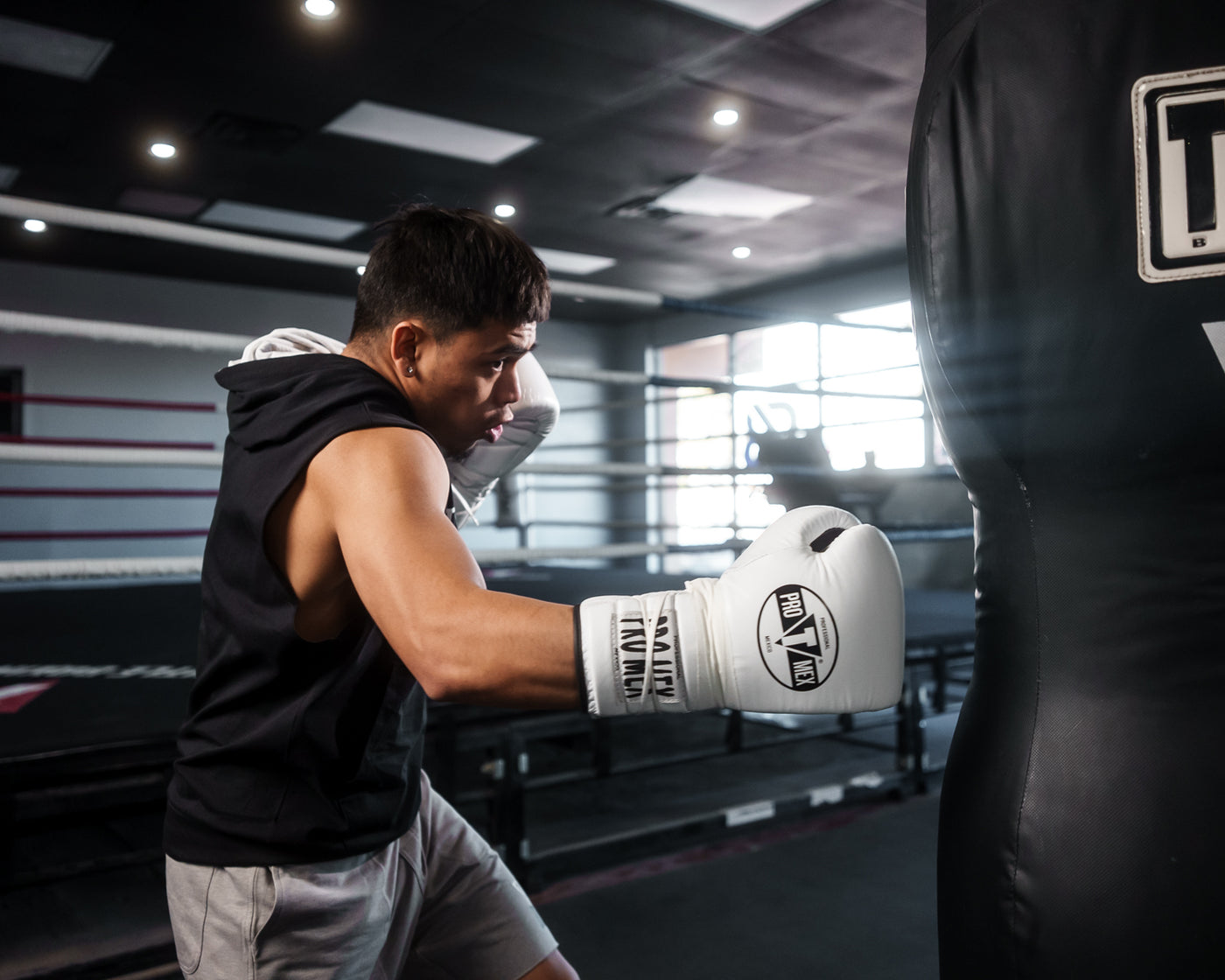 variant:white/black::Pro Mex Professional Lace Sparring Gloves V3.0 kid kitting bag right jab