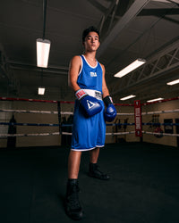 variant:lifestyle::TITLE Boxing Aerovent Elite Amateur Boxing Set 1 2.0 boy posing wearing blue side