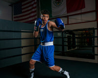 variant:lifestyle::TITLE Boxing Aerovent Elite Amateur Boxing Set 1 2.0 boy in boxing stance blue side