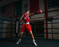 variant:lifestyle::TITLE Boxing Aerovent Elite Amateur Boxing Set 1 2.0 girl wearing red side punching