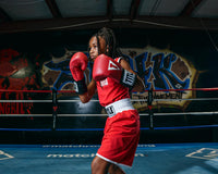 variant:lifestyle::TITLE Boxing Aerovent Elite Amateur Boxing Set 1 2.0 girl in boxing stance red side