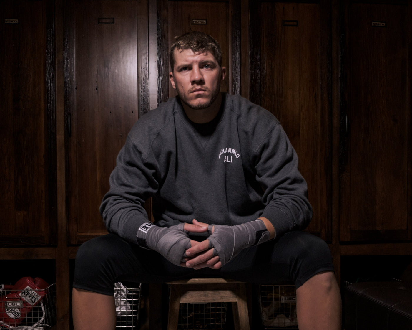 variant:grey::TITLE Boxing Select 180" Semi Elastic Mexican Hand Wraps guy sitting on stool