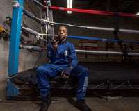 variant:navy::TITLE Boxing Select 180" Semi Elastic Mexican Hand Wraps guy rolling out hand wrap