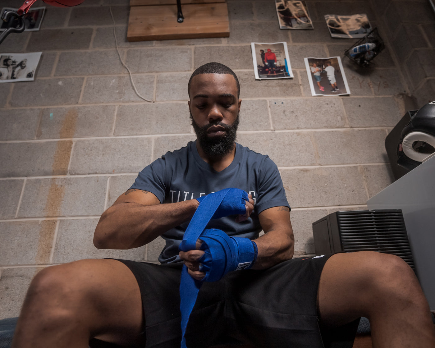 variant:royal::TITLE Boxing Select 180" Semi Elastic Mexican Hand Wraps guy sitting down putting on wraps
