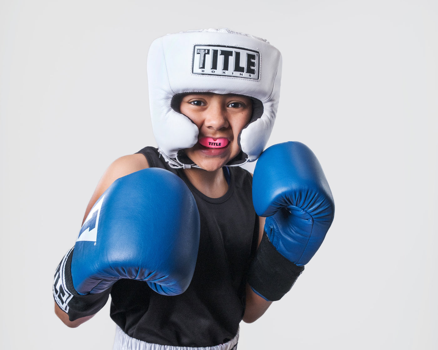 variant:pink::TITLE Boxing Super Shield X2 Mouth Guard in a young boxer's mouth