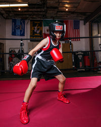 variant:black/red::TITLE Boxing Aerovent Elite Amateur Boxing Set 4 2.0 kid in boxing pose