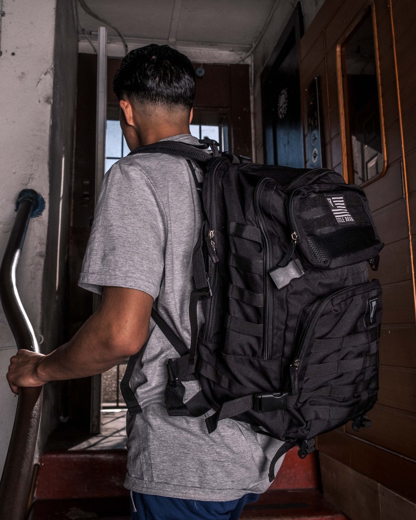 variant:Black::TITLE Boxing Tactical Combat Backpack man posing with backpack
