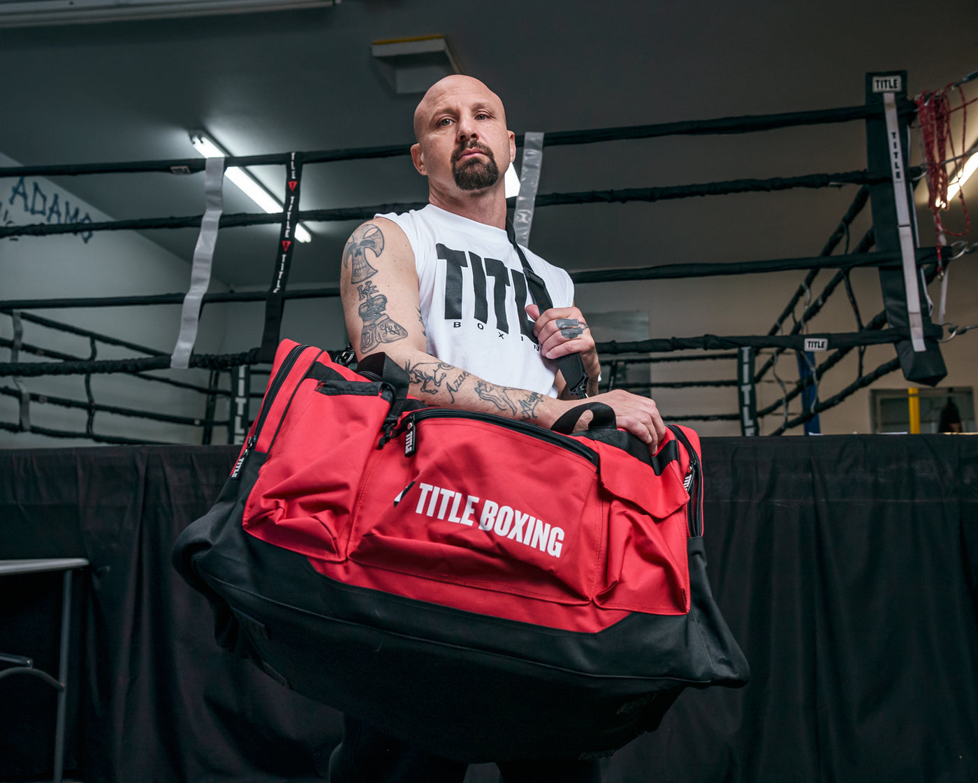 variant:red::TITLE Boxing Deluxe Gear Bag guy carrying bag infront of ring
