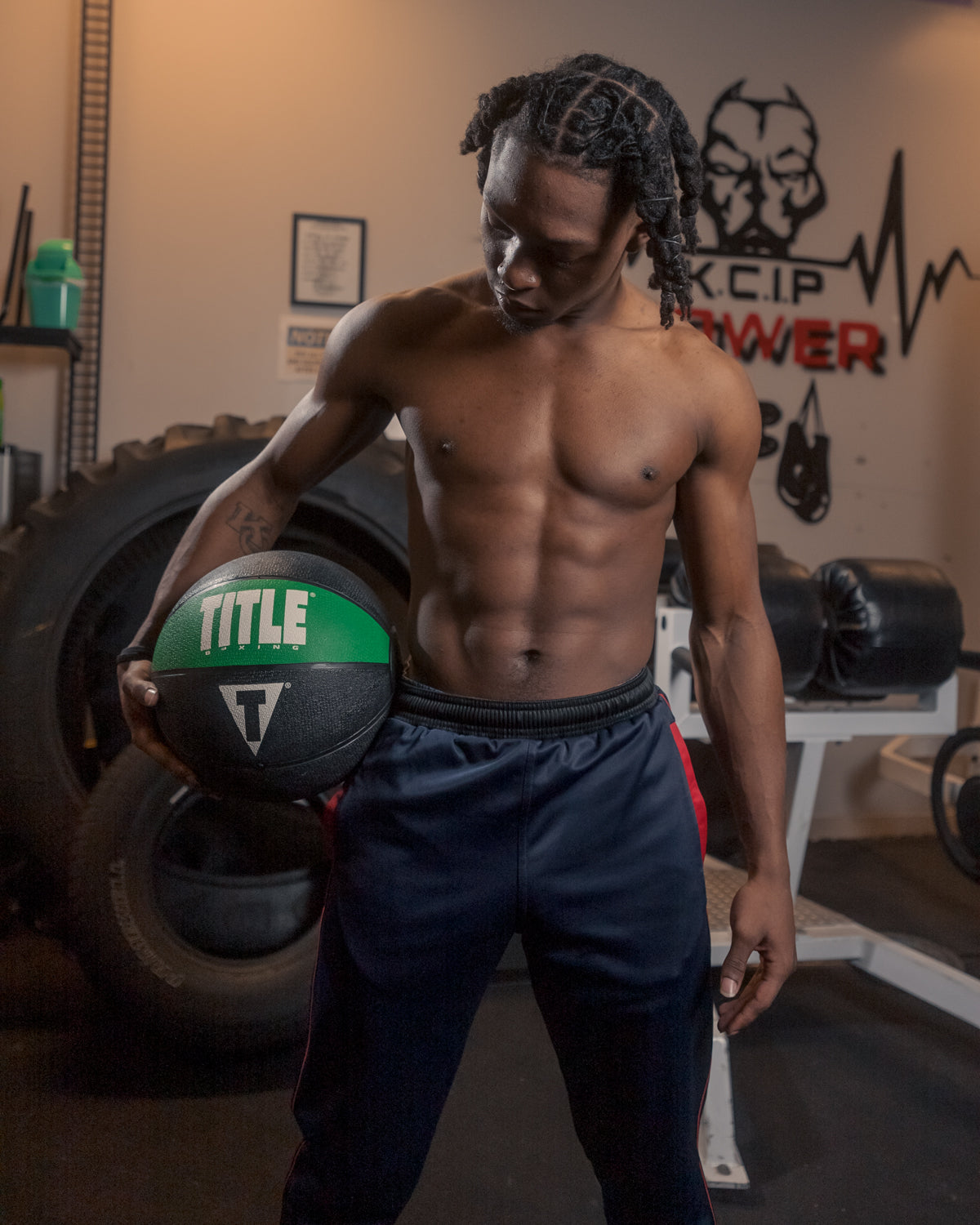 variant:15 lbs::TITLE Boxing Rubber Medicine Ball kid having ball on his hips