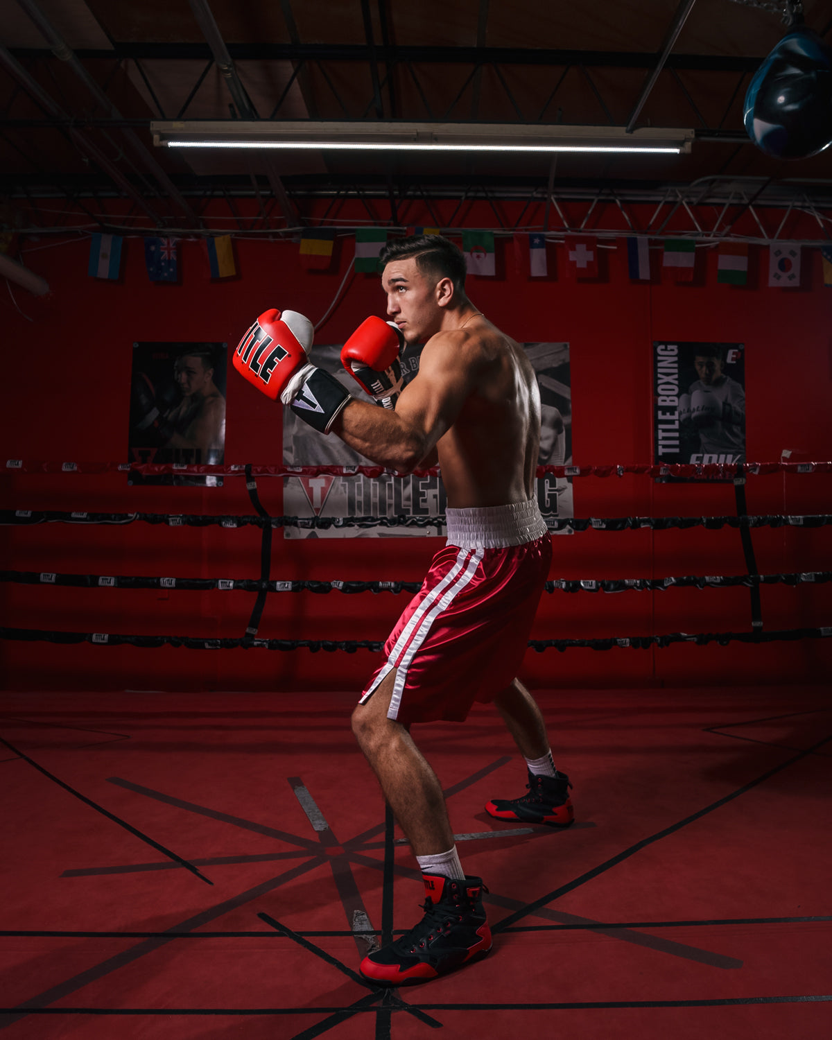 variant:black/red::TITLE Charged Boxing Shoes guy boxing stance view in ring
