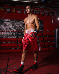 variant:black/red::TITLE Charged Boxing Shoes guy wearing gloves front view walking