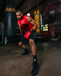 variant:Black::TITLE Boxing Predator Shoes 2.0 man posing in shoes