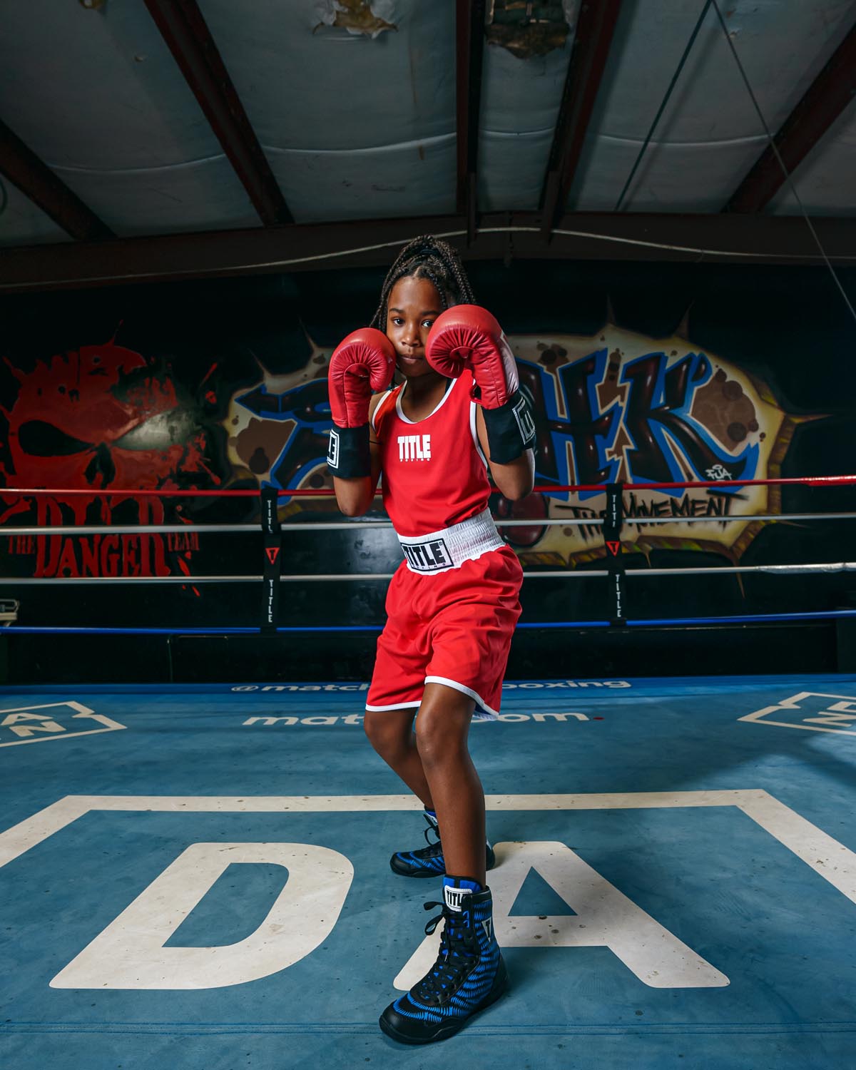 variant:Black/Blue::TITLE Boxing Predator Shoes 2.0 girl posing in shoes gloves up