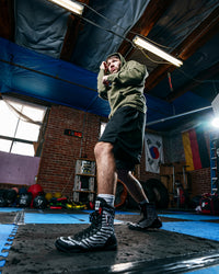 variant:Black/White::TITLE Boxing Predator Shoes 2.0 man posing in shoe