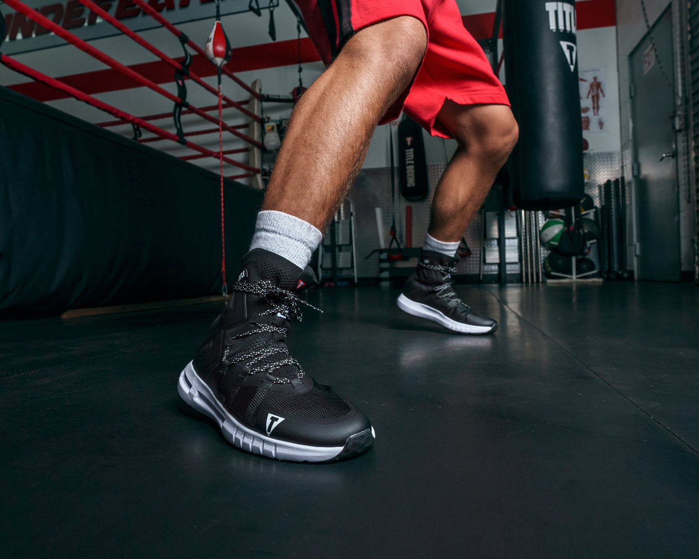 variant:black/black::TITLE Boxing High Point Boxing Shoes guy boxing infront of ring