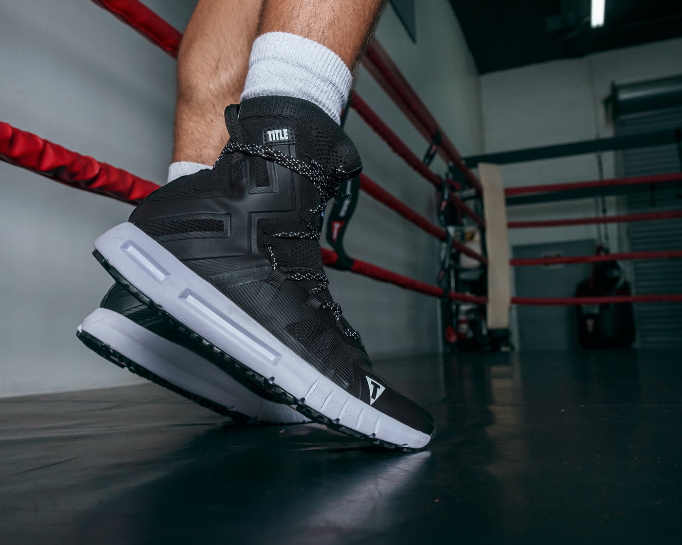 variant:black/black::TITLE Boxing High Point Boxing Shoes guy standing on tippy toes