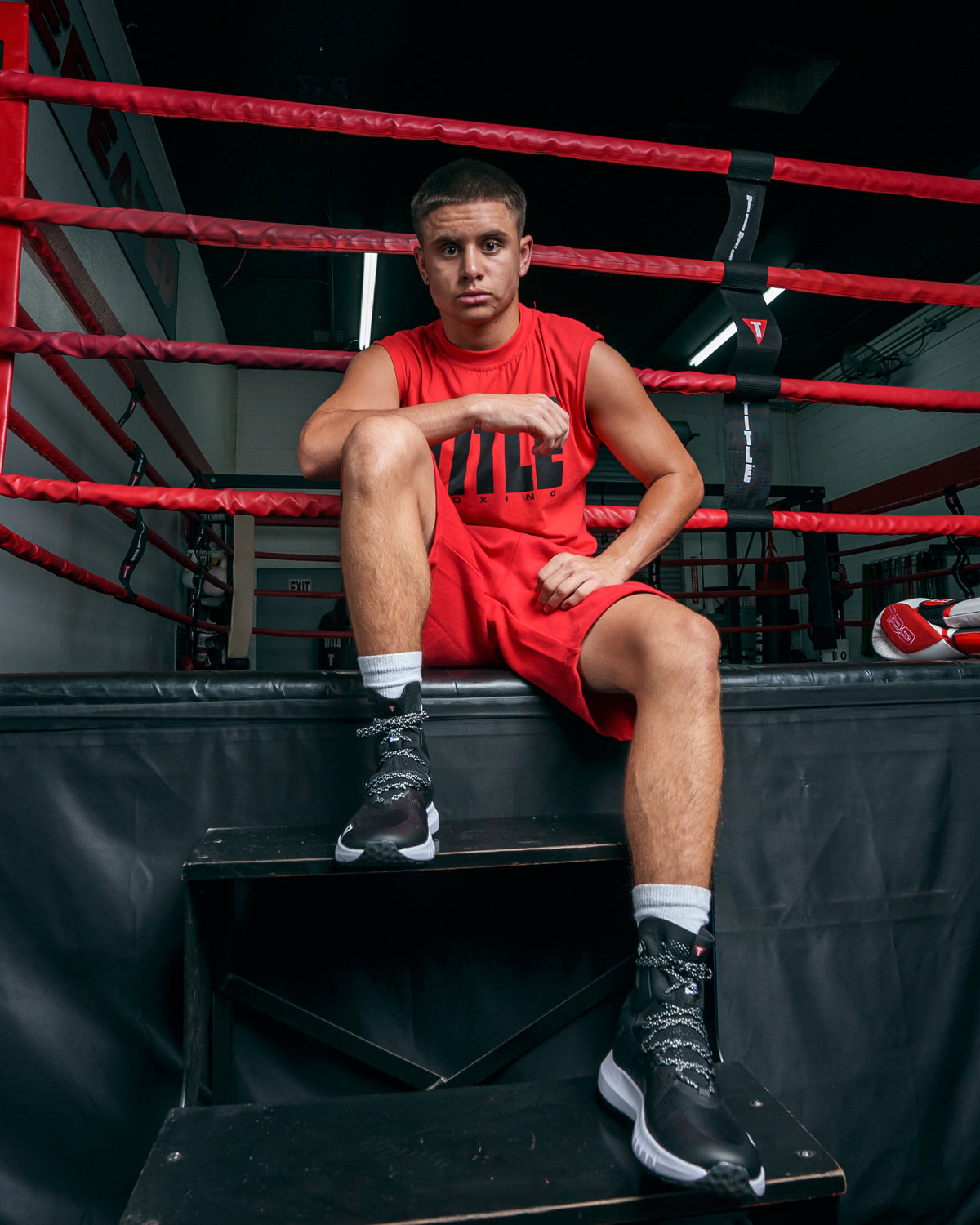 variant:black/black::TITLE Boxing High Point Boxing Shoes guy sittin gon steps in ring