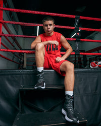 variant:black/black::TITLE Boxing High Point Boxing Shoes guy sittin gon steps in ring