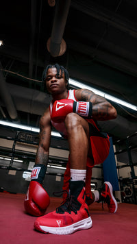variant:red/black::TITLE Boxing High Point Boxing Shoes guy kneeling down in ring