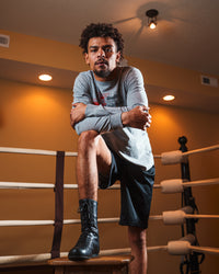 variant:black::TITLE Boxing High-Top Leather Boxing Shoes guy in ring on stool